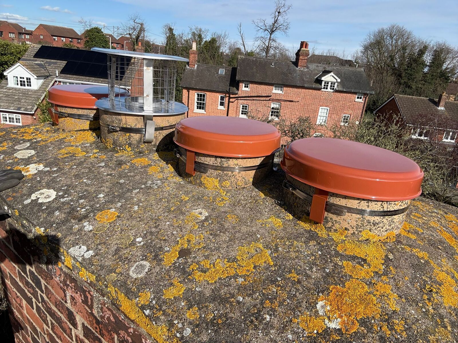 Capping cowls fitted to small pots bedded in cement flaunching